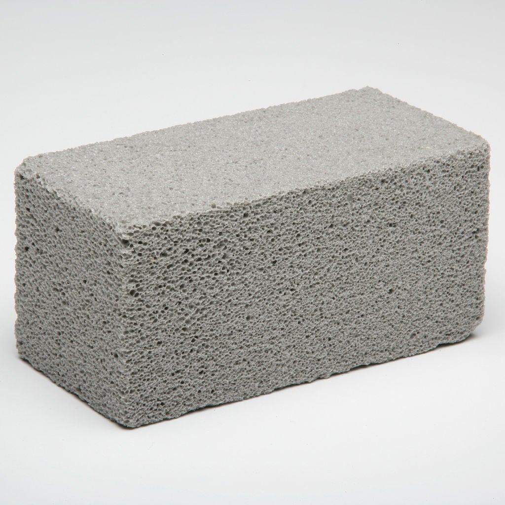 A PUMICE STONE BLOCK FOR SCOURING BURNED FOOD AND CARBON FROM GRILLS AND GRIDDLES WITHOUT MARRING THE SURFACE. BLOCK IS NATURAL, LIGHTGRAY, CINDERLIKE LAVA ROCK, FREE OF HARD PARTICLES.